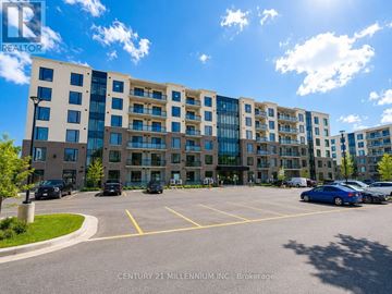 Waterloo condo for rent - A sunny day at the Century 21 Millennium, Inc. Brokerage building with cars parked in the lot.