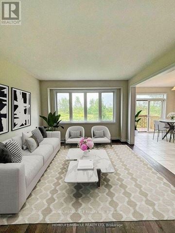 Welland (Dain City) apartment for rent - A well-lit living room with a grey sofa and a coffee table.