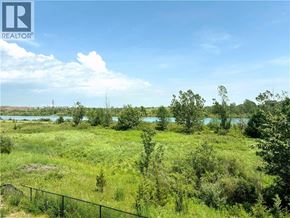Welland apartment for rent - A grassy field with a fence and trees in the distance.