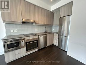 Toronto (Bayview Village) condo for rent - A kitchen with a refrigerator, oven, and microwave.