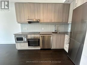 Toronto (Bayview Village) condo for rent - A kitchen with a refrigerator, oven, and microwave.