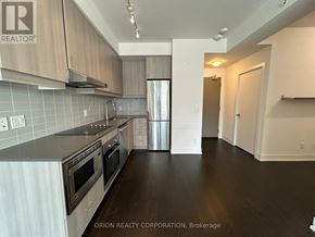 Toronto (Bayview Village) condo for rent - A kitchen with a stove top oven and a refrigerator.