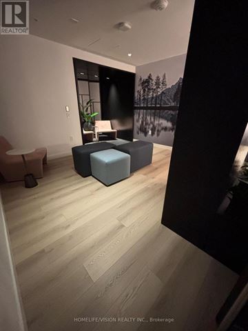 Toronto (Mount Pleasant West) condo for rent - A living room with a grey sofa and a wooden floor.
