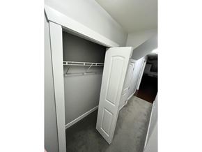 Surrey apartment for rent - A white closet with a white door is open.
