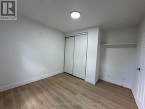 Toronto (Annex) multi-family for rent - A room with a white door and a wooden floor.