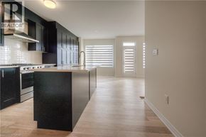 Oakville townhouse for rent - A kitchen with black cabinets and a wooden island.