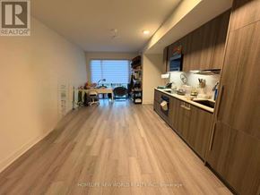 Toronto (Annex) condo for rent - A well-lit, spacious kitchen and dining area with wooden flooring and modern appliances.