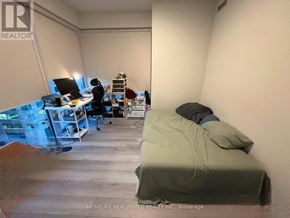 Toronto (Annex) condo for rent - A room with a bed, desk, and chair.