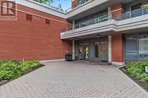 Markham (Unionville) condo for rent - A brick building with a balcony and glass doors.