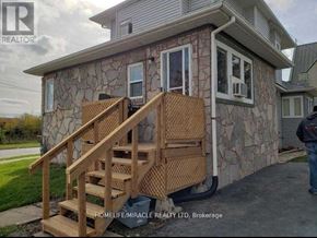 Oshawa (Central) apartment for rent - A stone house with a wooden staircase in front.