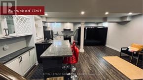 Markham (Wismer) apartment for rent - A kitchen with black appliances and white cabinets.
