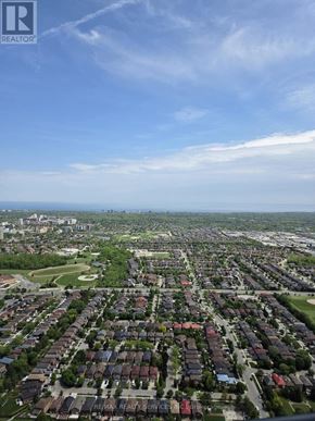 Mississauga (City Centre) condo for rent - A bird's eye view of a residential area with houses and greenery.