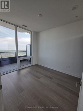 Mississauga (City Centre) condo for rent - A room with a view of the ocean through a sliding glass door.