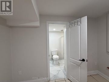 Mississauga (Meadowvale Village) apartment for rent - A white bathroom with a toilet and a door.