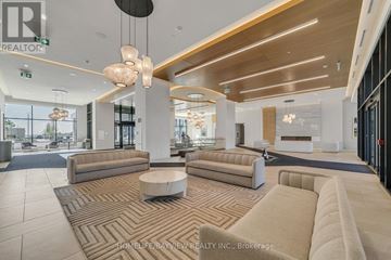 Vaughan (Vellore Village) condo for rent - A spacious living room with a large sectional sofa and a coffee table.