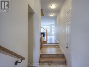 Oakville (Go Glenorchy) townhouse for rent - A hallway with a wooden floor and white walls.