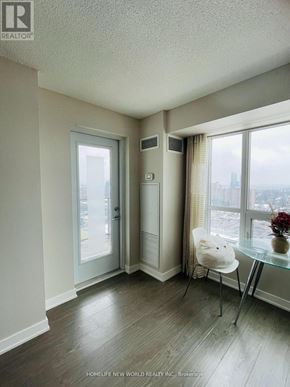Toronto (Tam O'shanter-Sullivan) condo for rent - A room with a glass table and a white chair.