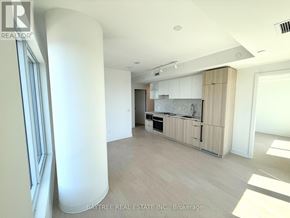 Toronto (Church-Yonge Corridor) condo for rent - A spacious kitchen with white cabinets and a marble backsplash is seen in the image.
