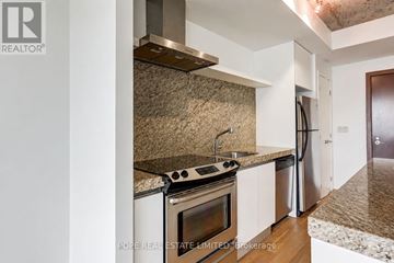 Toronto (Waterfront Communities) condo for rent - A kitchen with a stove top oven and a refrigerator.
