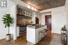 Toronto (Waterfront Communities) condo for rent - A modern kitchen with a marble backsplash and stainless steel appliances.