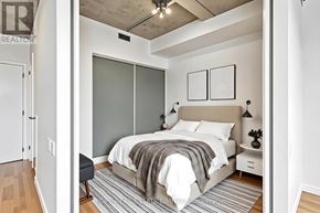Toronto (Waterfront Communities) condo for rent - A bedroom with a bed, nightstand, and a chair.
