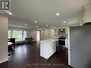 Hamilton (Dundas) apartment for rent - A kitchen with white appliances and a white island.