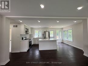 Hamilton (Dundas) apartment for rent - A spacious kitchen with white cabinets and a large island in the middle.