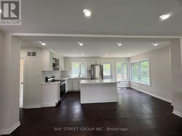 Hamilton (Dundas) apartment for rent - A spacious kitchen with white cabinets and a large island in the middle.
