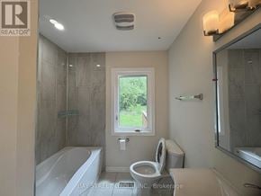 Hamilton (Dundas) apartment for rent - A bathroom with a tub, toilet, and sink.