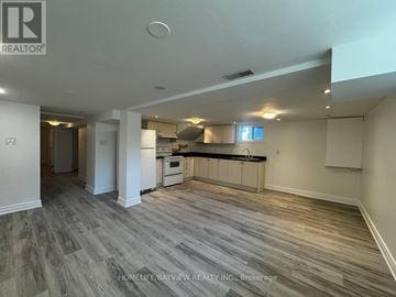 Newmarket (Bristol-London) apartment for rent - A spacious kitchen and living room with wood flooring and white walls.