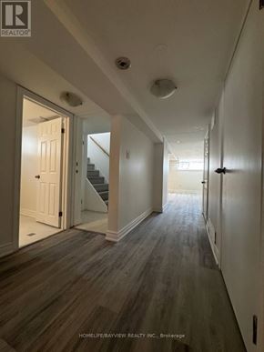 Newmarket (Bristol-London) apartment for rent - A long hallway with wood floors and white walls.