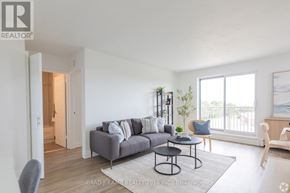 Hamilton (Rosedale) condo for rent - A living room with a grey couch, a small table, and a chair.