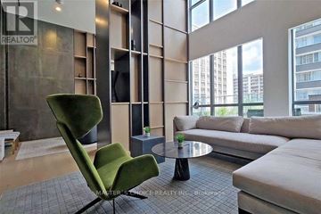 Toronto (Bay Street Corridor) condo for rent - A living room with a green chair and a grey sofa.