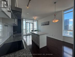 Toronto (Church-Yonge Corridor) condo for rent - A modern kitchen with a large island and a view of the city.
