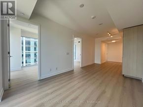 Toronto (Church-Yonge Corridor) condo for rent - A spacious room with wooden flooring and white walls.