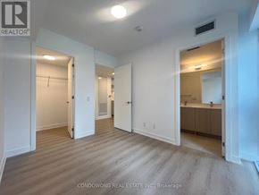 Toronto (Church-Yonge Corridor) condo for rent - A spacious room with white walls and wooden flooring, with a door open to another room.