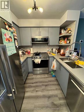Toronto (Willowdale West) condo for rent - A kitchen with a refrigerator, oven, and sink.