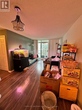 Toronto (Willowdale West) condo for rent - A room with a fish tank, a chair, and a table with a white tablecloth on it.