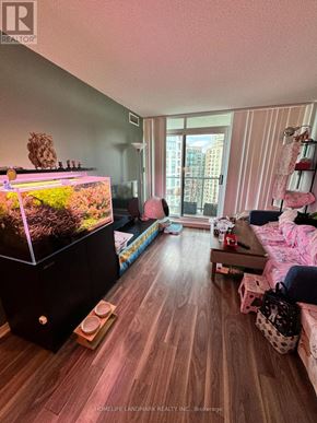 Toronto (Willowdale West) condo for rent - A fish tank is sitting on a wooden floor in a room.