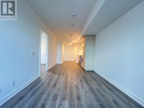 Toronto (Church-Yonge Corridor) condo for rent - A long hallway with wood flooring and white walls.