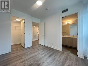 Toronto (Church-Yonge Corridor) condo for rent - A spacious room with wood flooring and white walls.