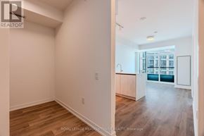 Mississauga (Central Erin Mills) condo for rent - A room with white walls and wooden flooring is shown.