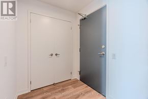 Mississauga (Central Erin Mills) condo for rent - A white door with a silver handle is on the left and a grey door with a silver handle is on the right.