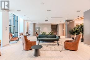 Mississauga (Central Erin Mills) condo for rent - A modern waiting room with a green sofa and orange chairs.
