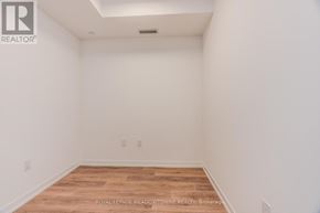 Mississauga (Central Erin Mills) condo for rent - A white room with a wooden floor and a ceiling light.