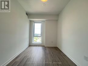 Toronto (Regent Park) condo for rent - Empty room with a window and wooden floor.