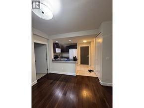 Vancouver apartment for rent - A room with a wooden floor and a white ceiling.