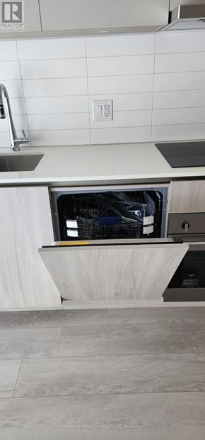 Toronto (Church-Yonge Corridor) condo for rent - A white kitchen with a dishwasher in the corner.