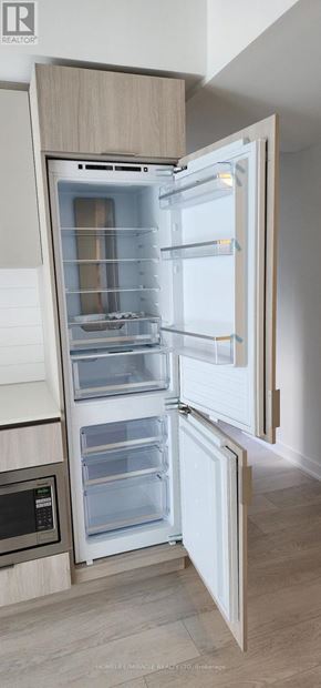 Toronto (Church-Yonge Corridor) condo for rent - A white refrigerator with its door open in a kitchen.
