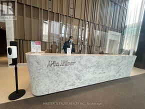 Toronto (North St. James Town) condo for rent - A reception desk with a person standing behind it.